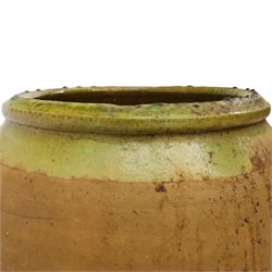 Large Continental terracotta olive jar, of typical baluster form with a green glaze band decoration, H46cm