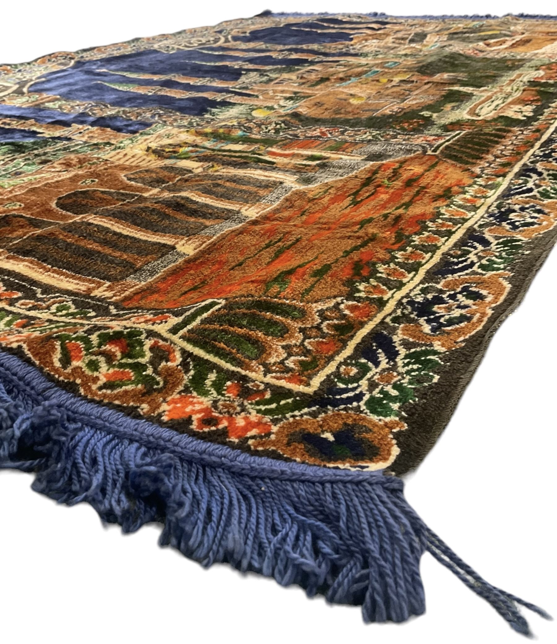 Indigo ground family prayer rug, depicting Masjid al-Haram in Mecca within floral design borders 