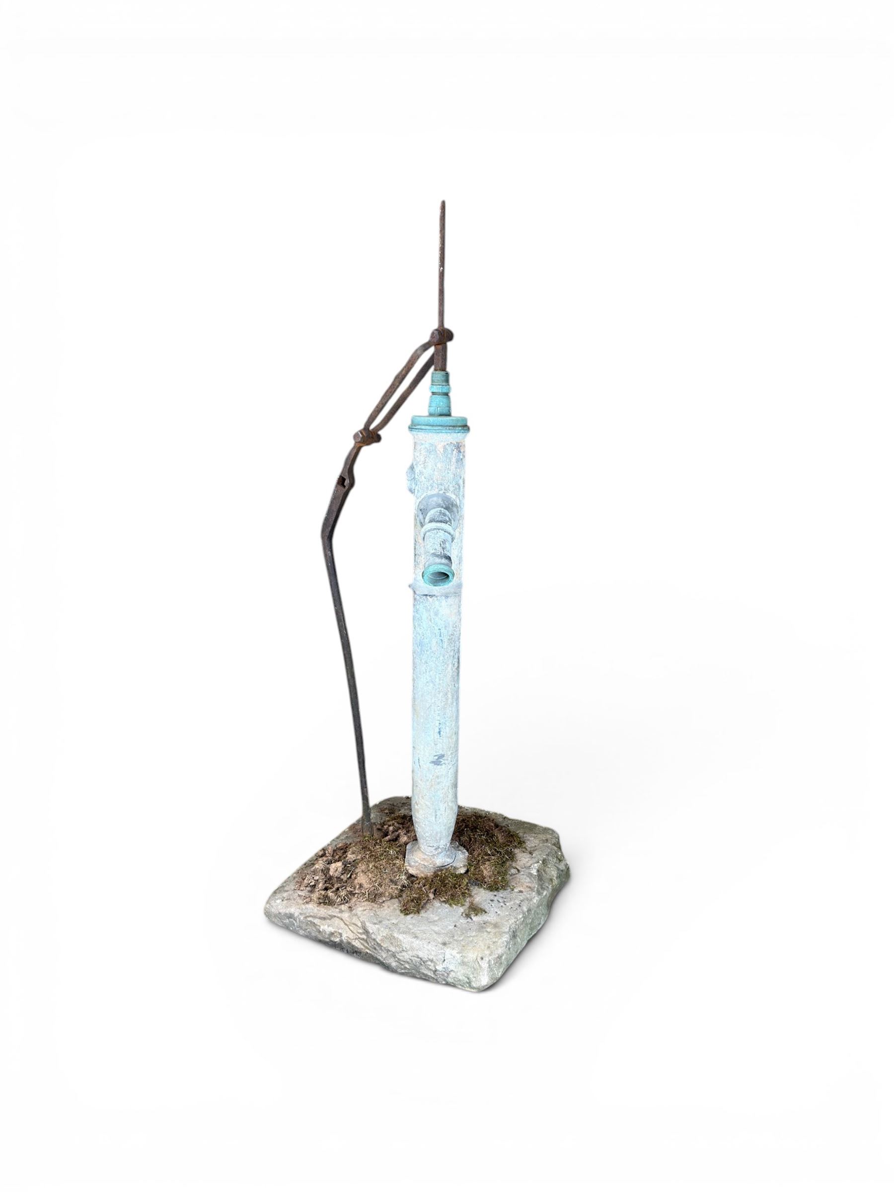 Georgian period lead garden water pump, with iron handle, set in square stone base