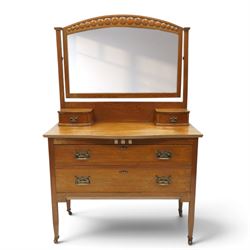 Manner of Liberty & Co. - Arts & Crafts oak dressing chest, the arched swing mirror with roundel-carved frieze and bevelled plate, serpentine-front top with two raised trinket drawers, fitted with two drawers with brass Art-Nouveau poppy handle-plates, on square tapering supports with castors