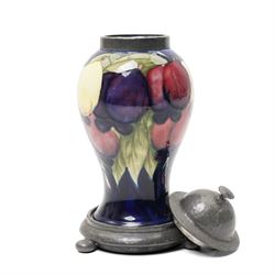 William Moorcroft for Liberty Wisteria pattern baluster vase on a dark blue ground with planished domed pewter cover and collar on a pewter stand marked Tudric Moorcroft 01308 Overall height 21cm