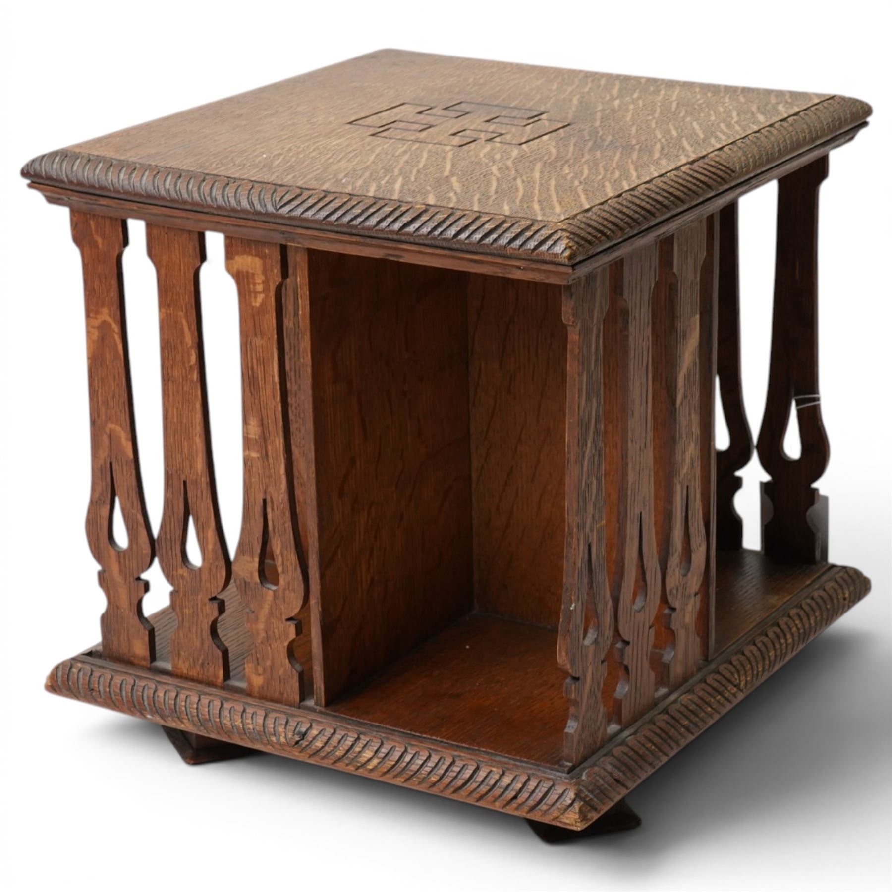 Early 20th century tabletop oak revolving bookcase, of square section upon short platform base 