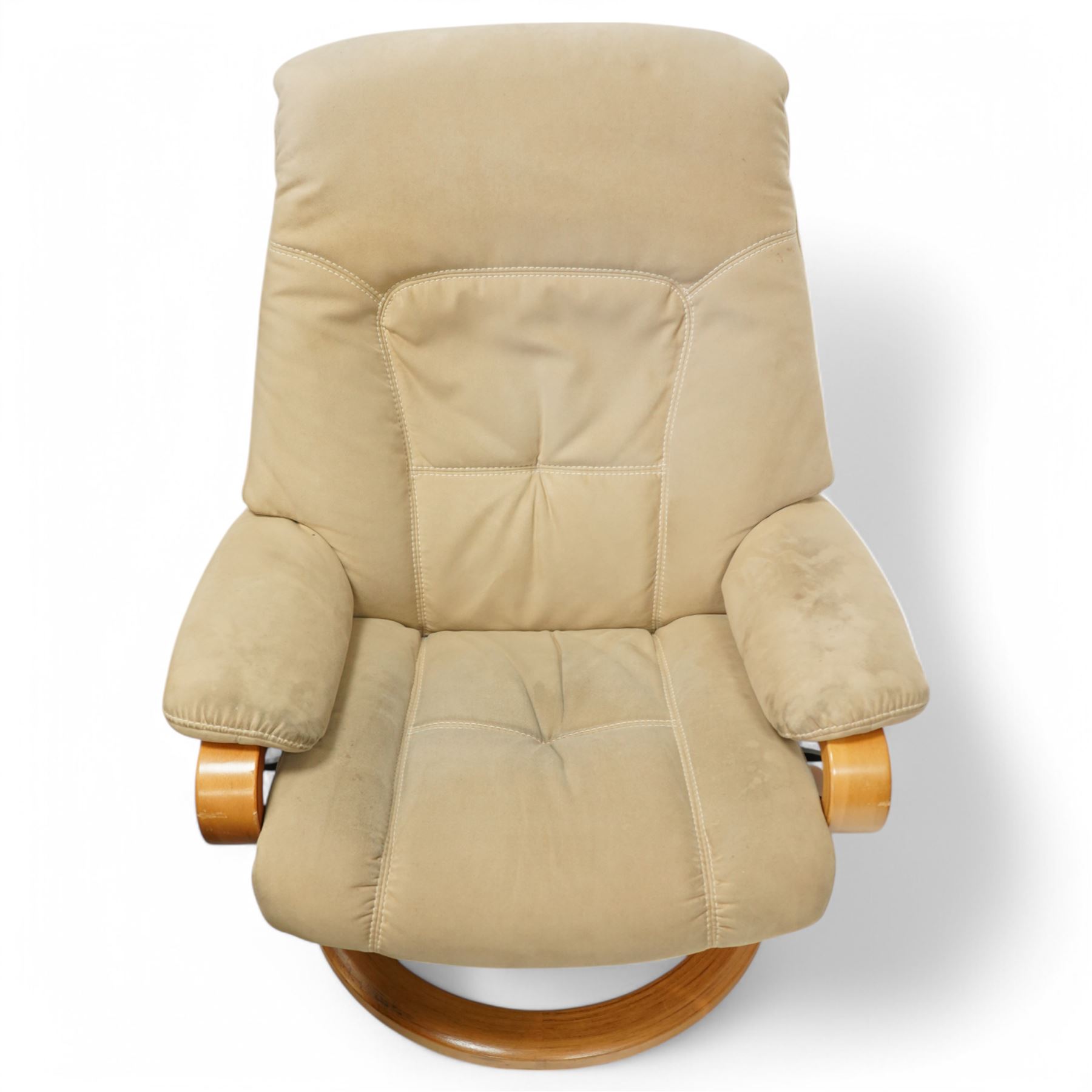 Himolla - A pair of swivel reclining chairs, beige upholstered with padded arms and high back rest, raised on a laminated circular wooden base with swivel mechanism 