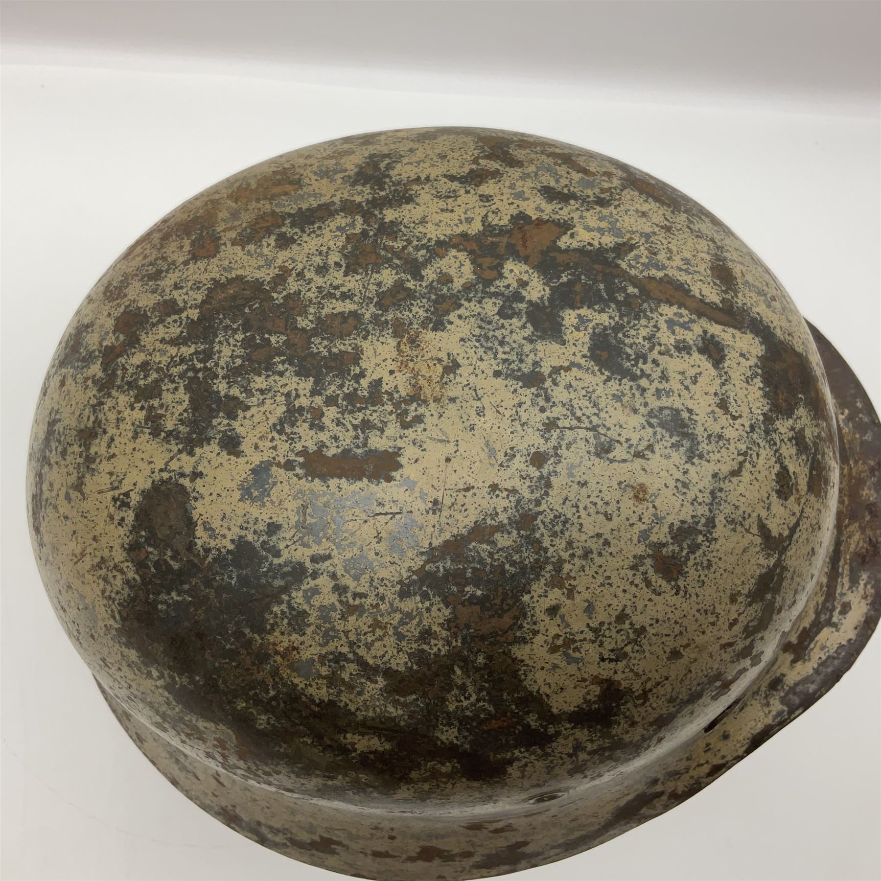 WW2 German Infantry M40 steel helmet with tropical finish and traces of single decal; with chin strap and leather liner marked 57 twice in red; back apron stamped 11 38