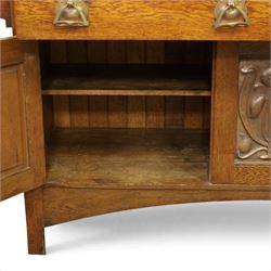 Art Nouveau oak mirrored sideboard, in the manner of Liberty's London, the raised back fitted with bevelled mirror plates divided by turned supports beneath a projecting cornice, above two drawers and panelled cupboard doors, the central panel applied with stylised floral carved panel, raised on shaped feet