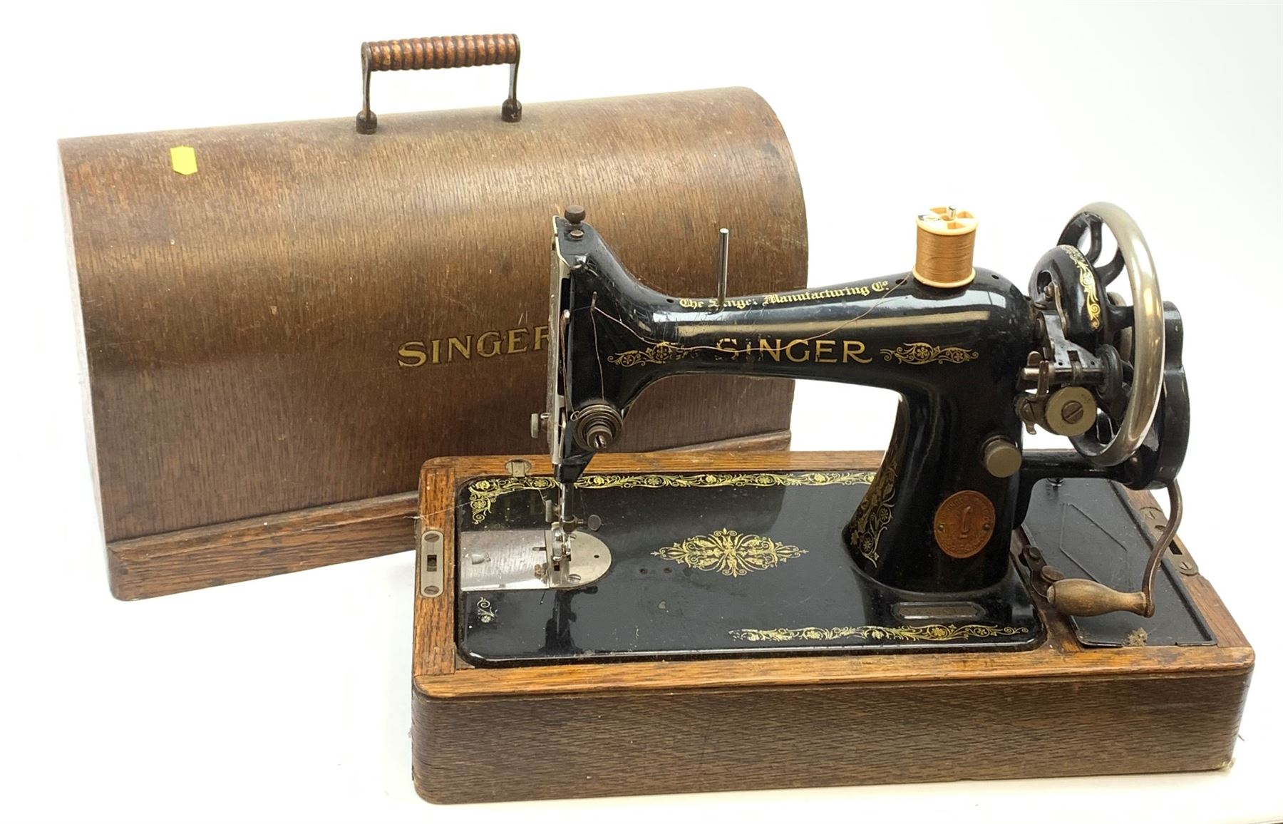 A cased vintage Singer hand crank sewing machine. Decorative Antiques