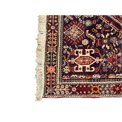 Persian Heriz crimson ground rug, field with large central lozenge surrounded by stylised plant motifs in a mauve background, guarded border with repeating foliage