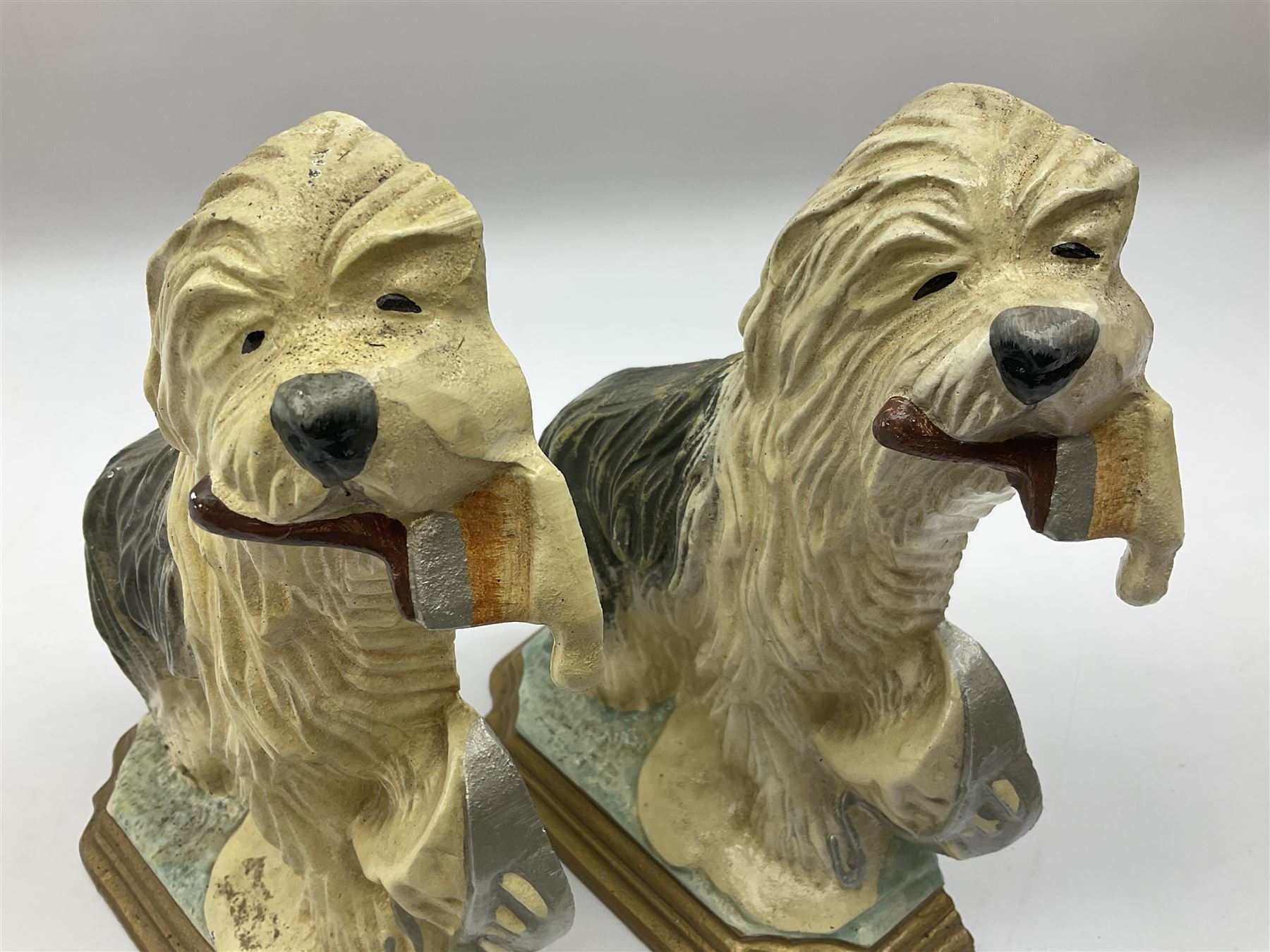 Pair of cast iron Dulux Old English sheepdog doorstops together with another modelled as a golfer