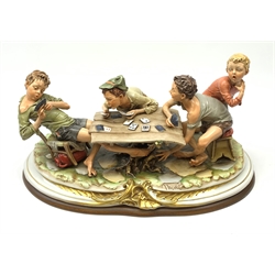 Large Capodimonte figure group 'The Card Cheat', modelled as four card players, signed Merli, raised on a wooden base L56cm 