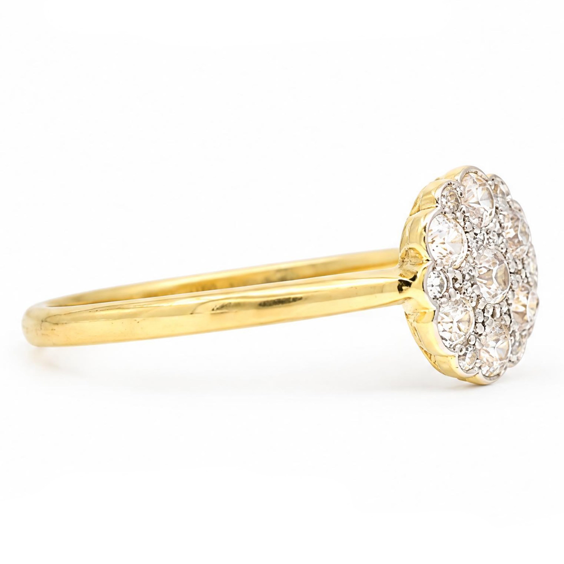 Early 20th century diamond daisy cluster ring, milgrain and bead set with thirteen old cut diamonds by Ahronsberg Brothers, stamped 18ct, total diamond weight approx 0.45 carat