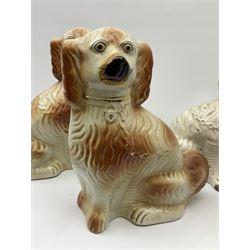 A pair of Victorian Staffordshire white glazed spaniels H34cm, together with a pair of Victorian Staffordshire brown and white glazed spaniels H35cm. 