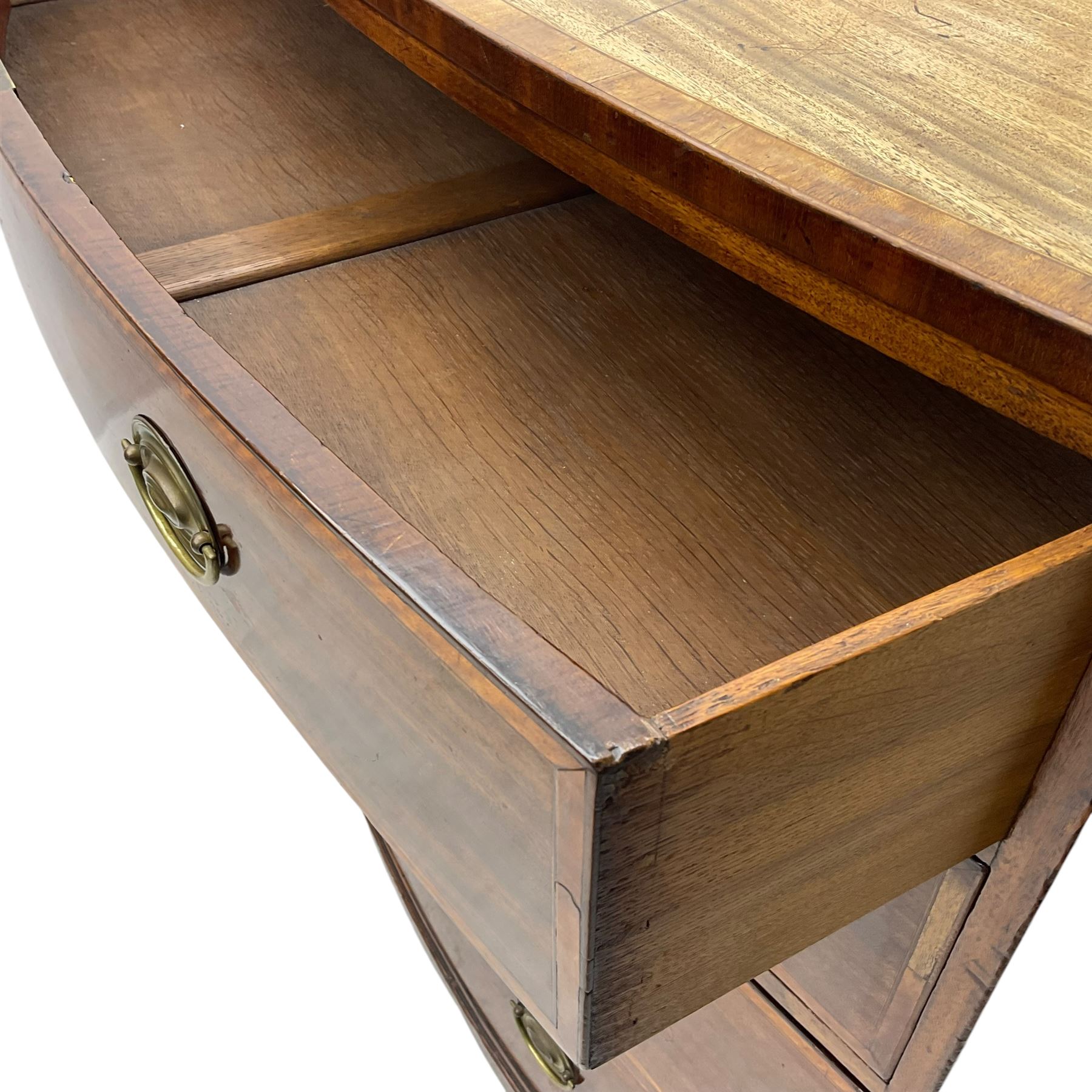 George III mahogany bow-front chest of drawers, four graduated drawers with oval brass handles, raised on splayed bracket feet with a shaped apron