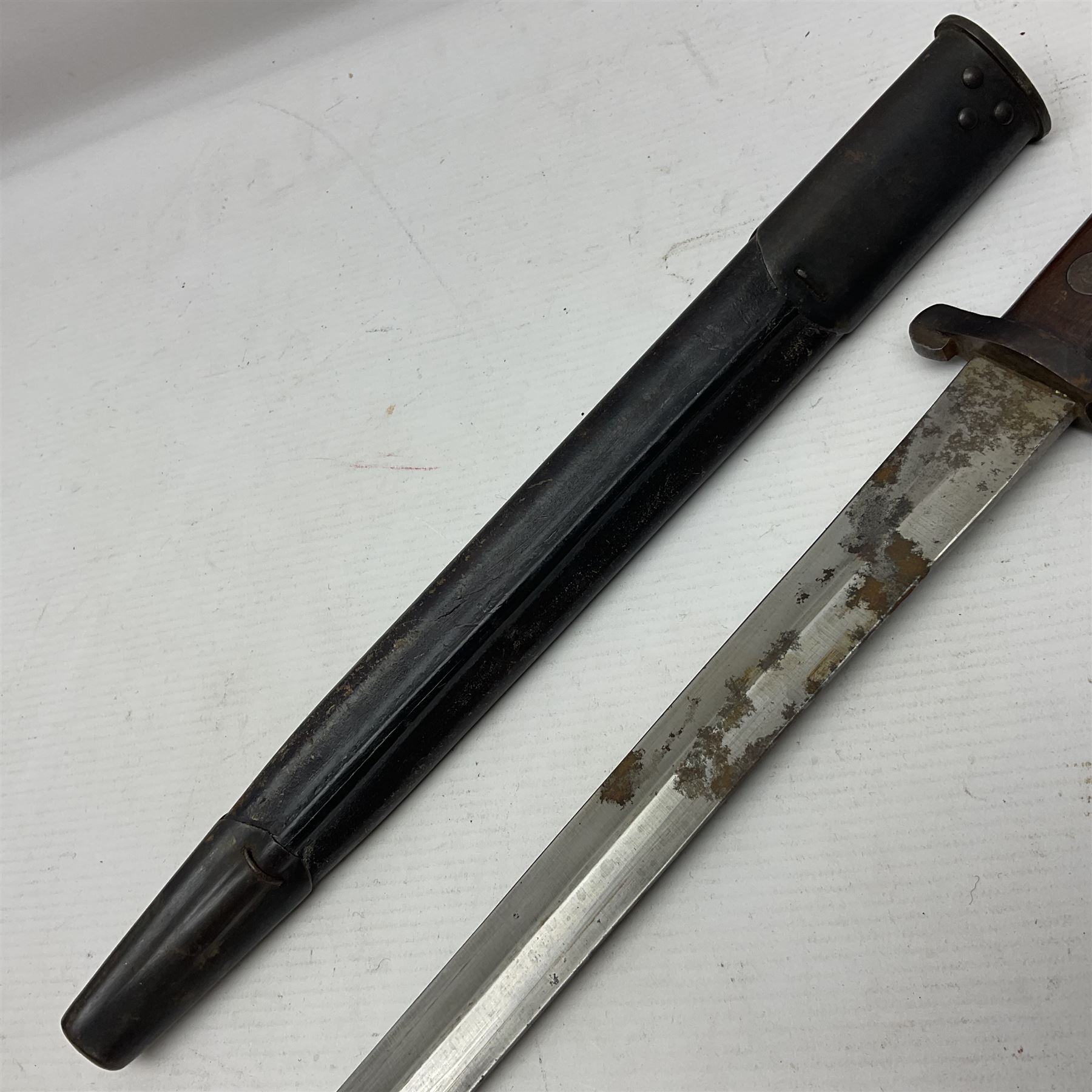 British Pattern 1888 knife bayonet, the 30.5cm double edged blade with raised central medial ridge; in leather covered scabbard L40.5cm overall