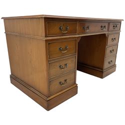 Cherrywood twin pedestal desk, rectangular leather inset top over central fall front with keyboard slide and two drawers, fitted with two drawers and cupboard, on bracket feet
