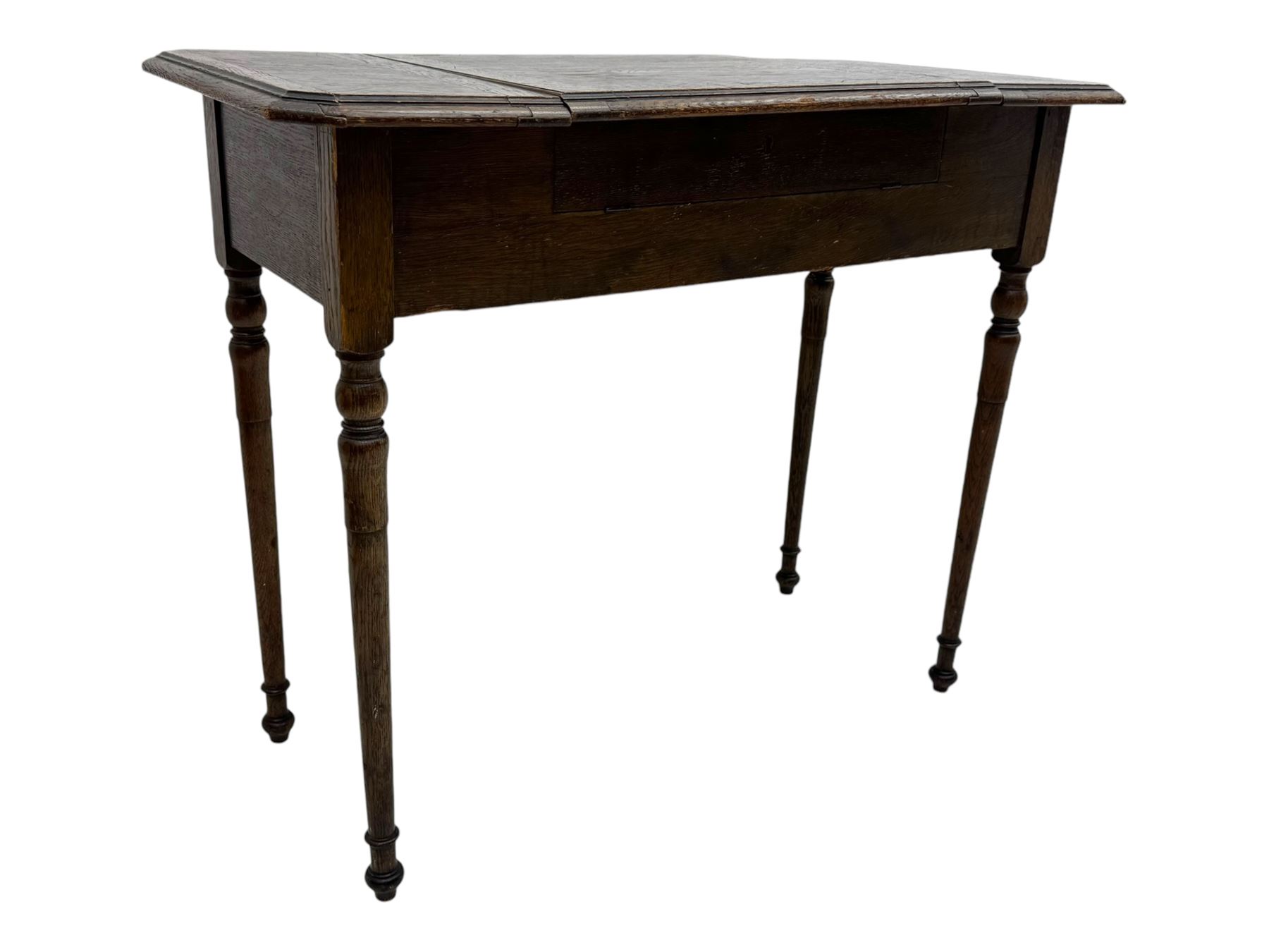 Edwardian oak metamorphic 'Britisher Writing Table', rectangular hinged top revealing correspondence compartments and hinged writing surface with underside storage, flanked by twin hinged compartments with dividers, on turned supports