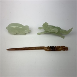 A carved jade pig, L6.5cm, together with a carved jade horse, L10cm, and a russet jade hair pin with carved zoomorphic terminal, L17cm.