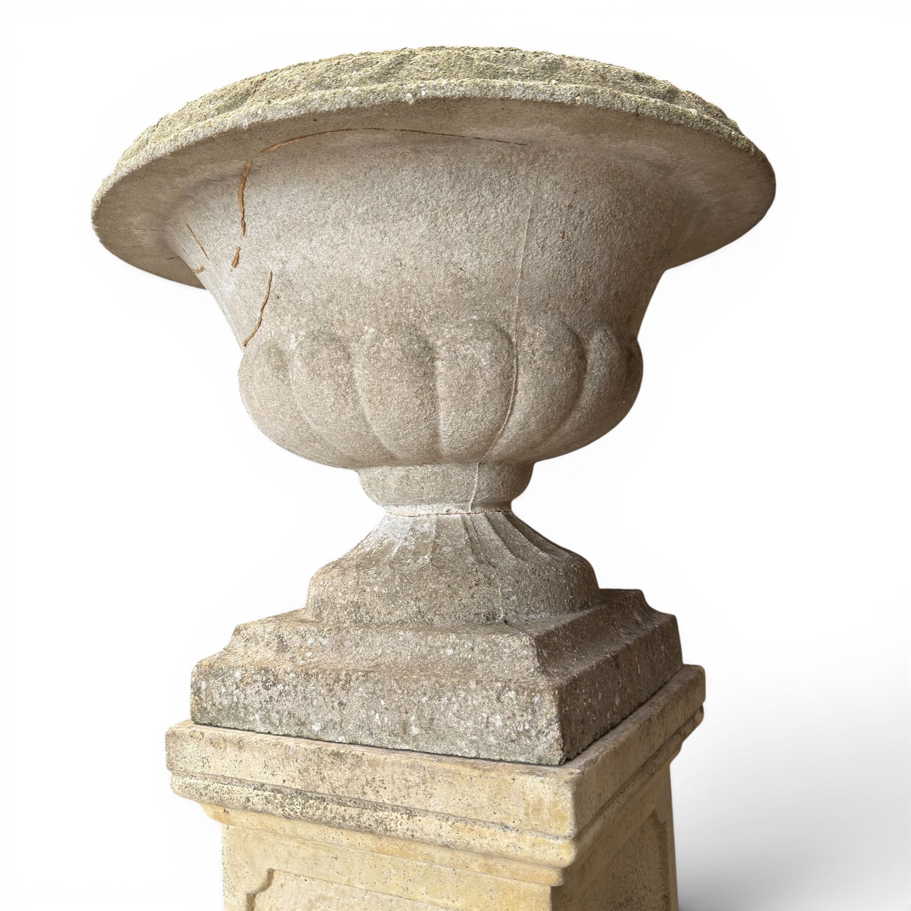 Weathered cast stone statue of a child and urn planter on pedestal along with three piece bird bath