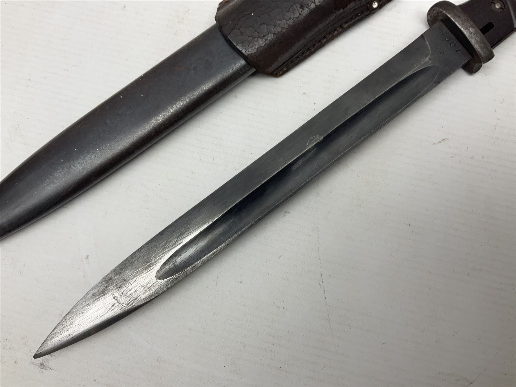 WWII German K98 Mauser bayonet by E. & F. Horster, the 24.5cm fullered blade marked 43aSW for 1943, numerous inspection marks to blade and pommel, bakelite grips and bluing to metal parts; in steel scabbard with corresponding numbers and leather frog L42cm overall