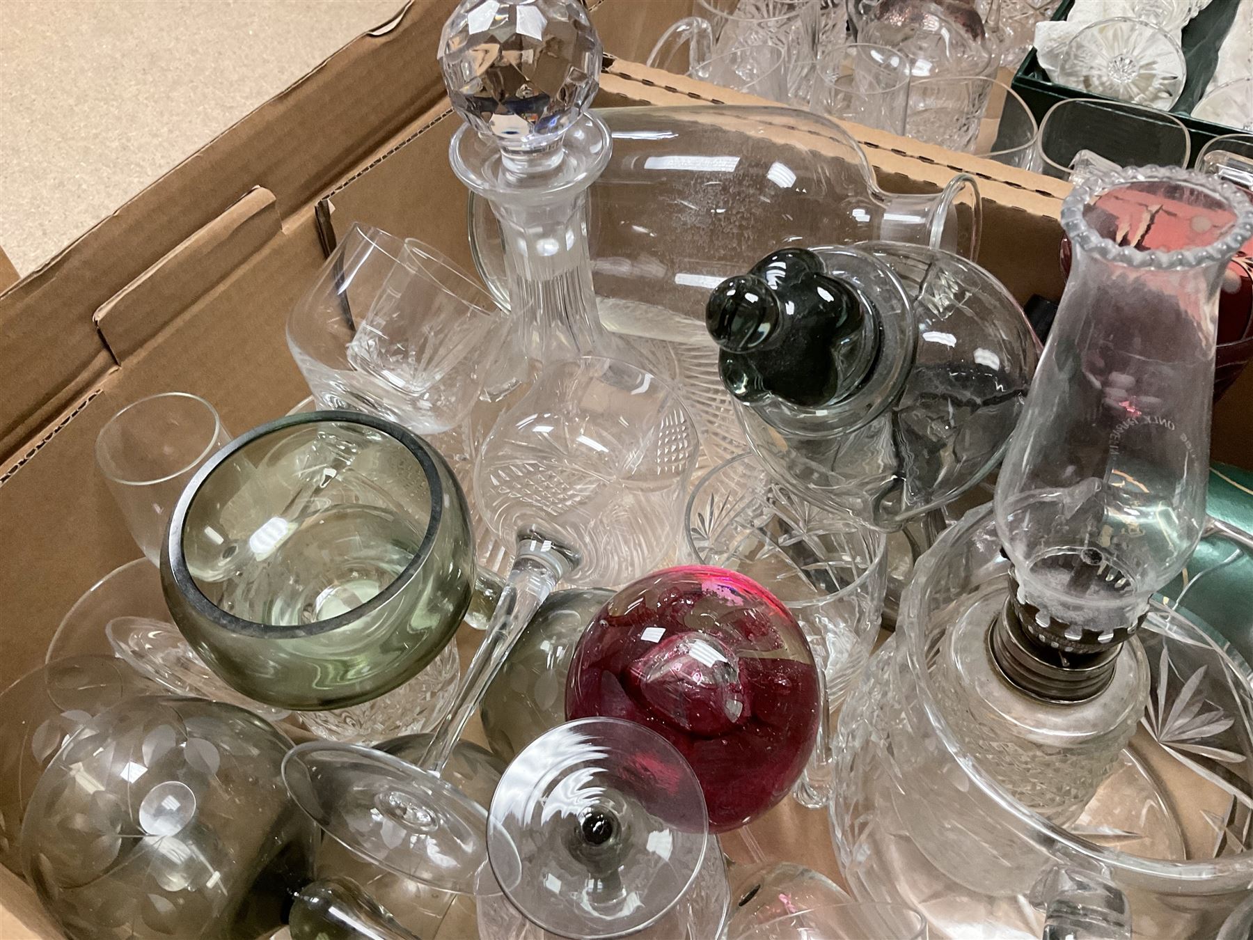 Caithness 'Fireball' paperweight, together with four cased Tyrone Crystal glasses, glass oil lamp, three glass decanters etc, in two boxes