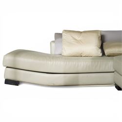 Christian Liaigre (1943-2020) - 'Arpege' handmade L-shaped sectional sofa, upholstered in neutral leather, with broad squared arms, deep seat cushions, angled chaise section, loose back cushions, raised on block feet