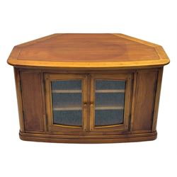 Contemporary cherry wood corner TV unit, canted top over central glazed double doors opening to shelves for media storage, flanked by side storage compartments, on a plinth base