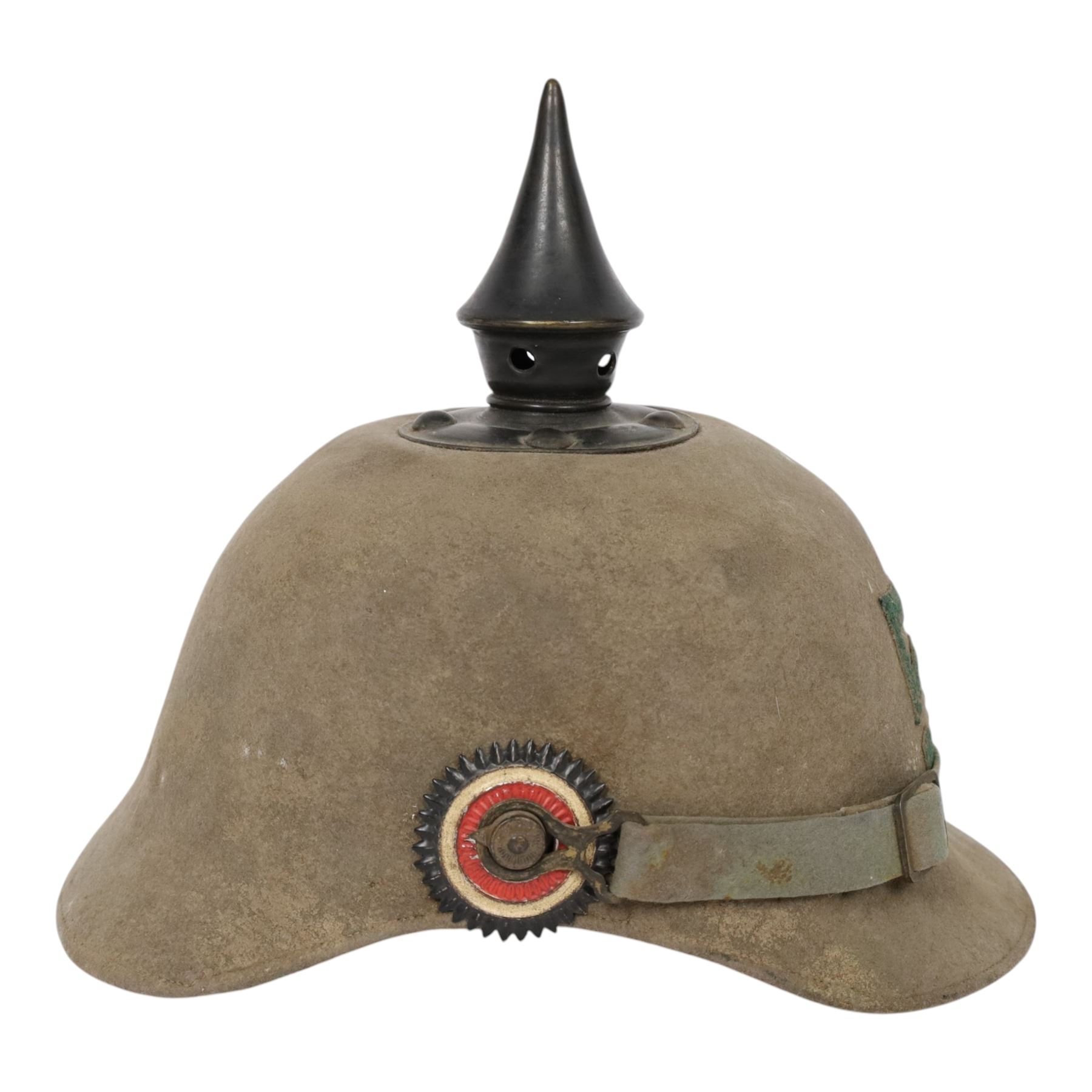 WWI Prussian 57th regiment Ersatz felt Pickelhaube, the grey felt skull with steel spike finial, stitched with green felt 57, chin strap, one side with a black cockade, the other black and red