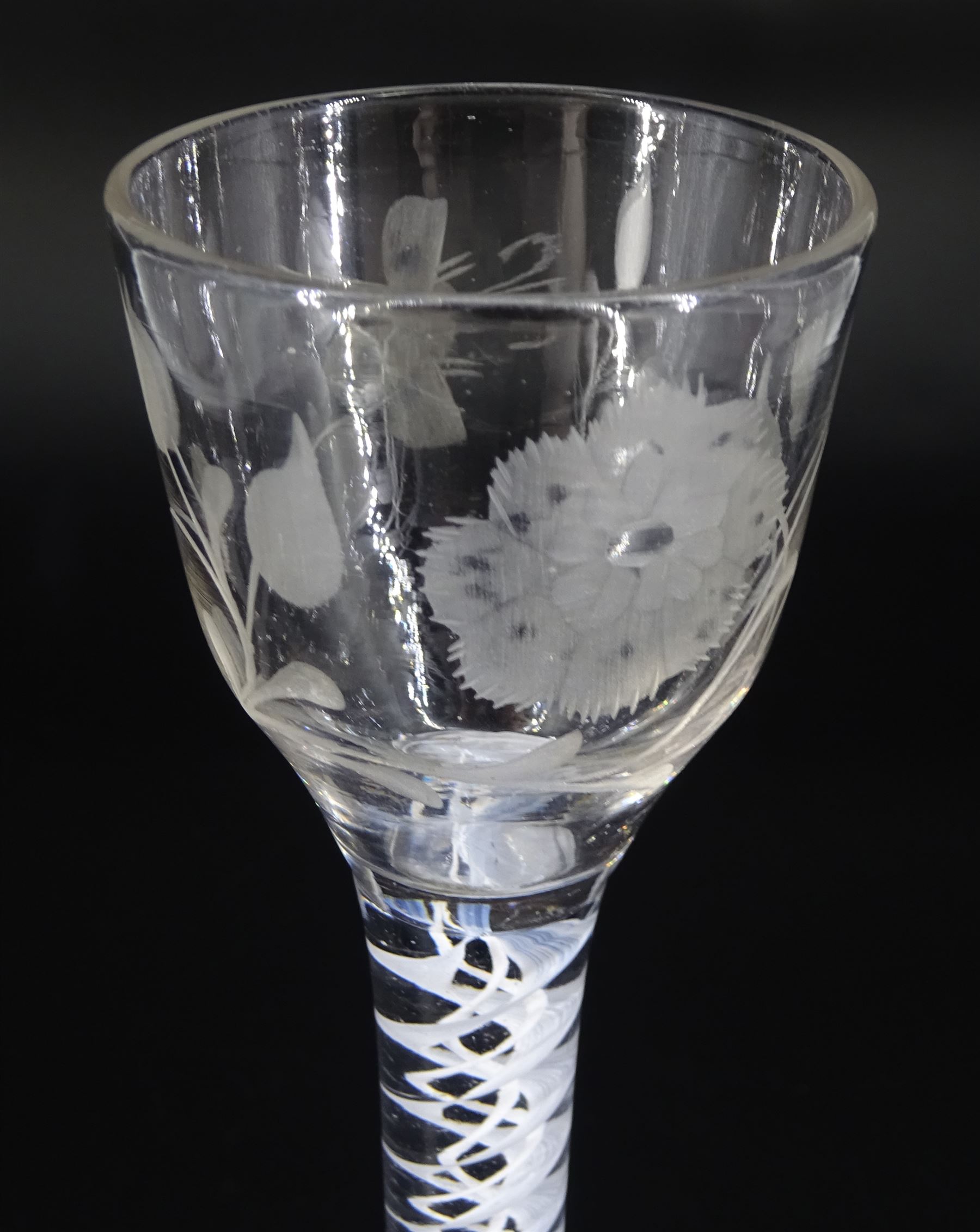 18th century drinking glass of possible Jacobite interest, the ogee bowl engraved with carnation and bee, upon a double series opaque twist stem and conical foot, H16cm