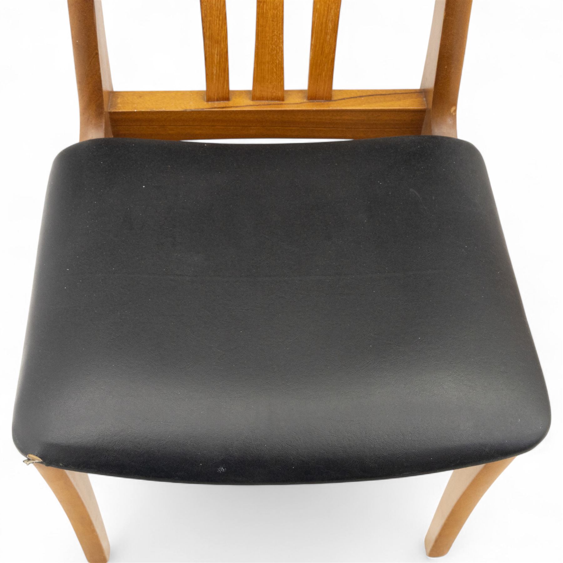 Sutcliffe of Todmorden - mid 20th century ‘S-Form’ teak dining table and chairs, the circular storable extending table with plain veneered top on tapered supports, together with matching dining chairs upholstered in black vinyl, with curved slat backs and shaped front supports, reflecting the sleek organic styling characteristic of 1960s British modern furniture design (Chairs H 93cm, W 46cm, D 46cm) (Extended 168cm)