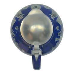 Wim Muhlendyck (1905-1986),  saltglaze stoneware jug of globular form with pulled and applied handle and ribbed neck with white cover, with stylised cockerels and flowers on a dark blue ground, with makers mark beneath, H22cm