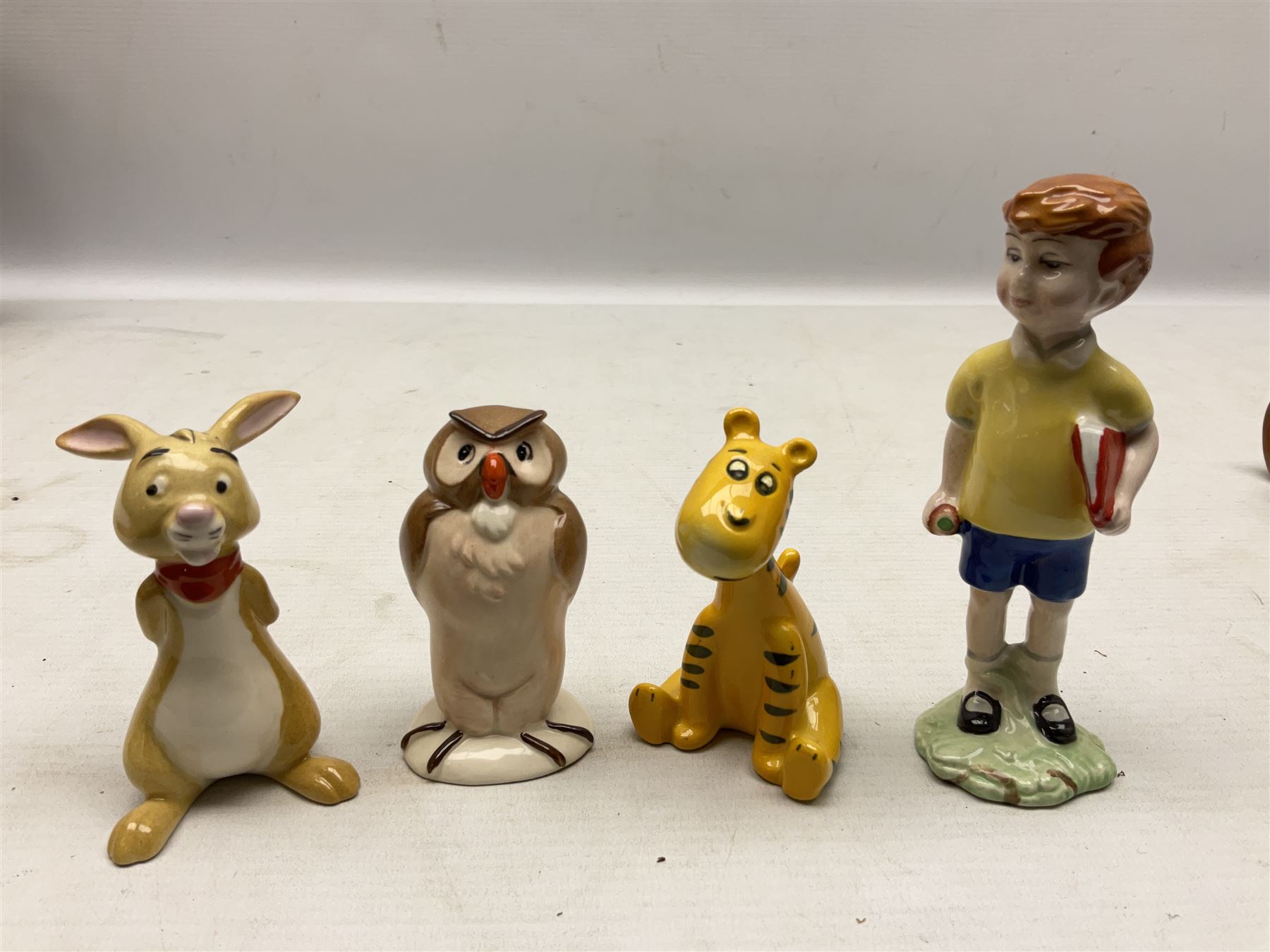 Set of eight Winnie the Pooh Beswick figures, comprising Christopher Robin, Winnie the Pooh, Tigger, Piglet, Rabbit, Eeyore, Owl and Kanger, six with original boxes, tallest H12cm  