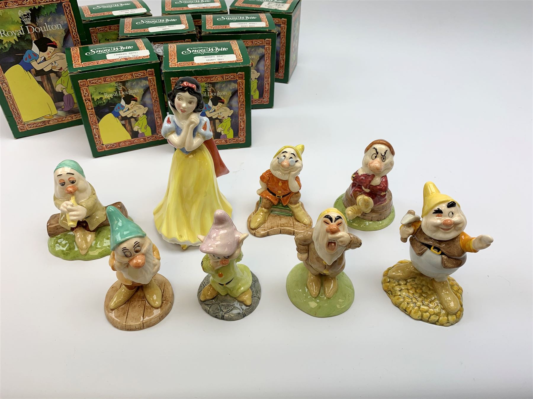 Royal Doulton Snow White and the Seven Dwarfs figurines, each with box. (8). 