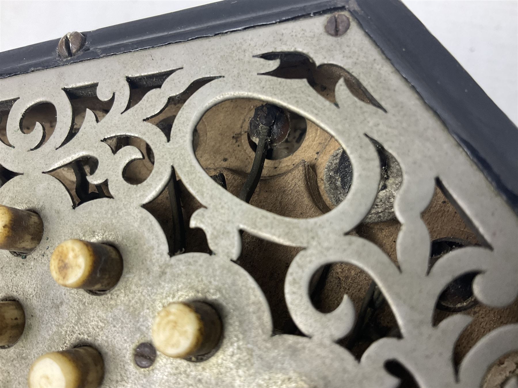 19th century Lachenal concertina of hexagonal form with fretworked nickel ends and thirty-four plus one bone buttons; straps marked Lachenal & Co Makers London and wooden handle stamped English Make Trade Mark L16cm