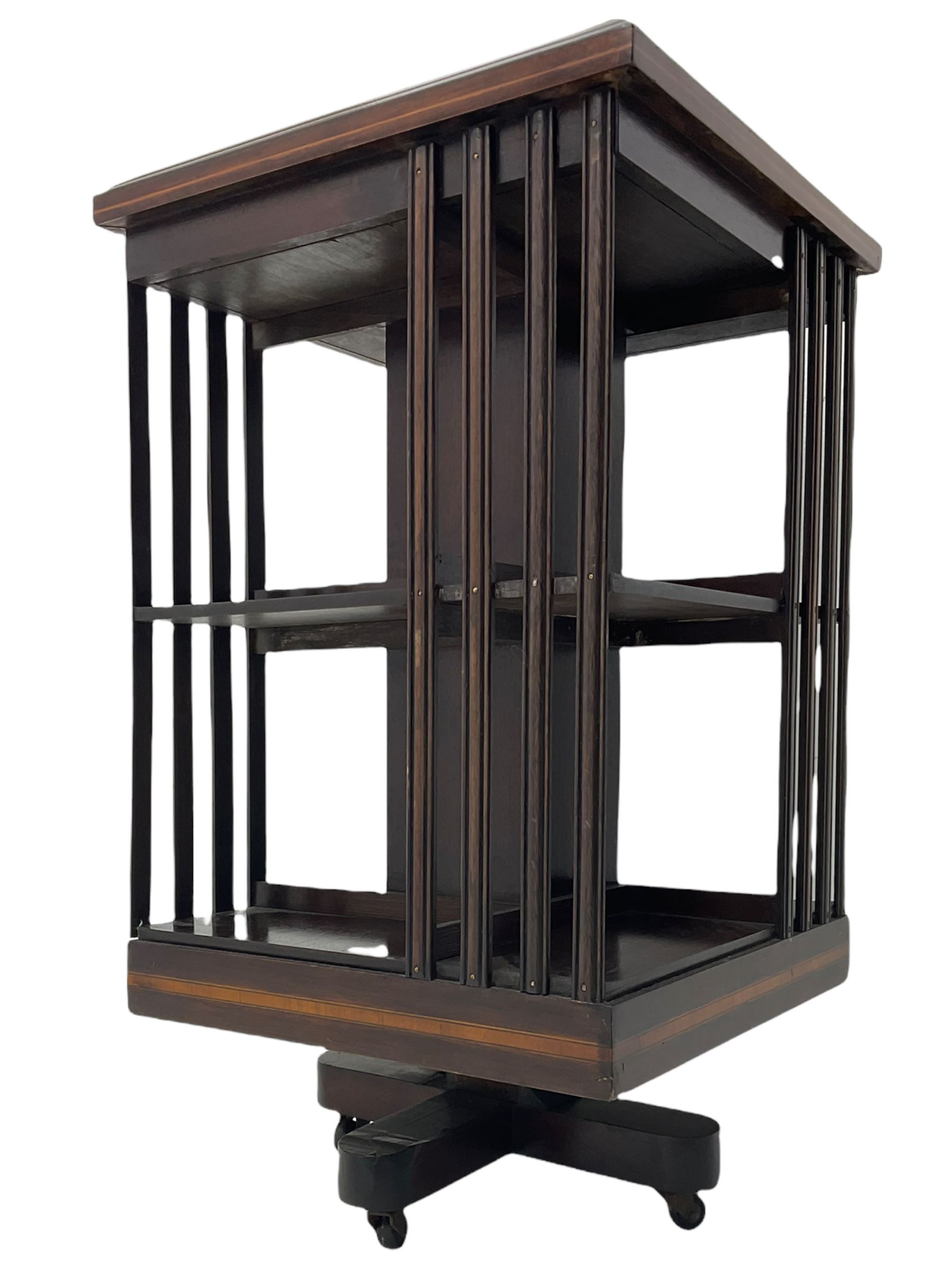 20th century mahogany revolving bookcase, inlaid centre motif, satinwood banded border