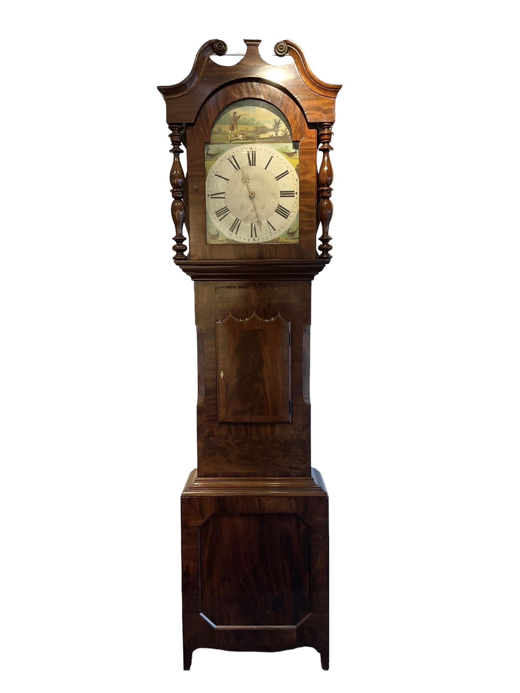 Late 19th century 30 hour Yorkshire mahogany longcase clock, with a swans necked pediment and break arch hood door flanked by two ring turned pilasters, trunk with a short door with a bone escutcheon on a wide plinth with a recessed panel, painted dial with a depiction of a sportsman to the arch and game birds to the spandrels, Roman numerals, minute markers and brass hands, chain driven countwheel striking movement. With weight and pendulum.