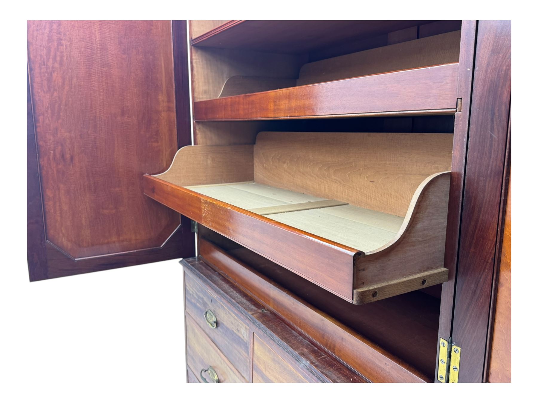 George III mahogany linen press cupboard, projecting moulded cornice over two panelled doors, the interior fitted with two slides and shelf, two short and two long drawers below, shaped apron over bracket feet 