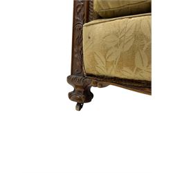 Early 20th century mahogany framed three-piece lounge suite - three-seat camelback sofa (W203cm, D105cm); pair of matching armchairs (W95cm, D96cm); upholstered in neutral foliate pattern fabric, carved with trailing leafy branches, ball and claw carved feet with brass castors 