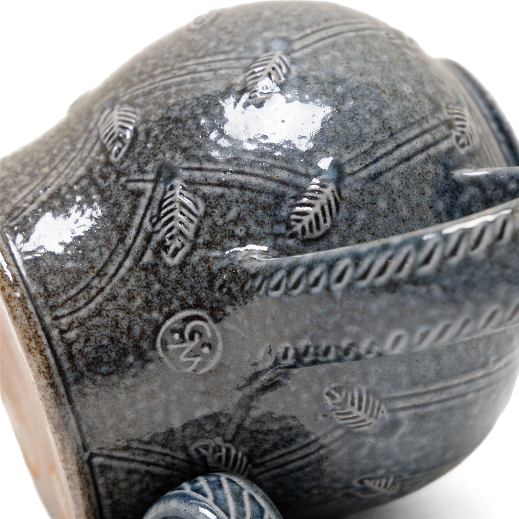 Gus Mableson - two studio pottery teapots, the larger example with a repeating floral pattern upon a brown ground, each with impressed makers marks below the handle, largest H18cm