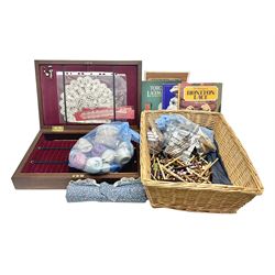 Collection of lace making wooden bobbins, together with lace making books and a handmade storage box