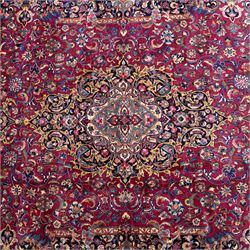 Large North East Persian Meshed hand-knotted carpet with signature, raspberry red field with central shaped cusped medallion, densely decorated with intricate arrangement of scrolling vines, and florals designs within conforming spandrels and a dark ground border richly ornamented with stylized flowers, vase and bird ornamentation, enclosed by guard stripes, with cotton fringe ends
