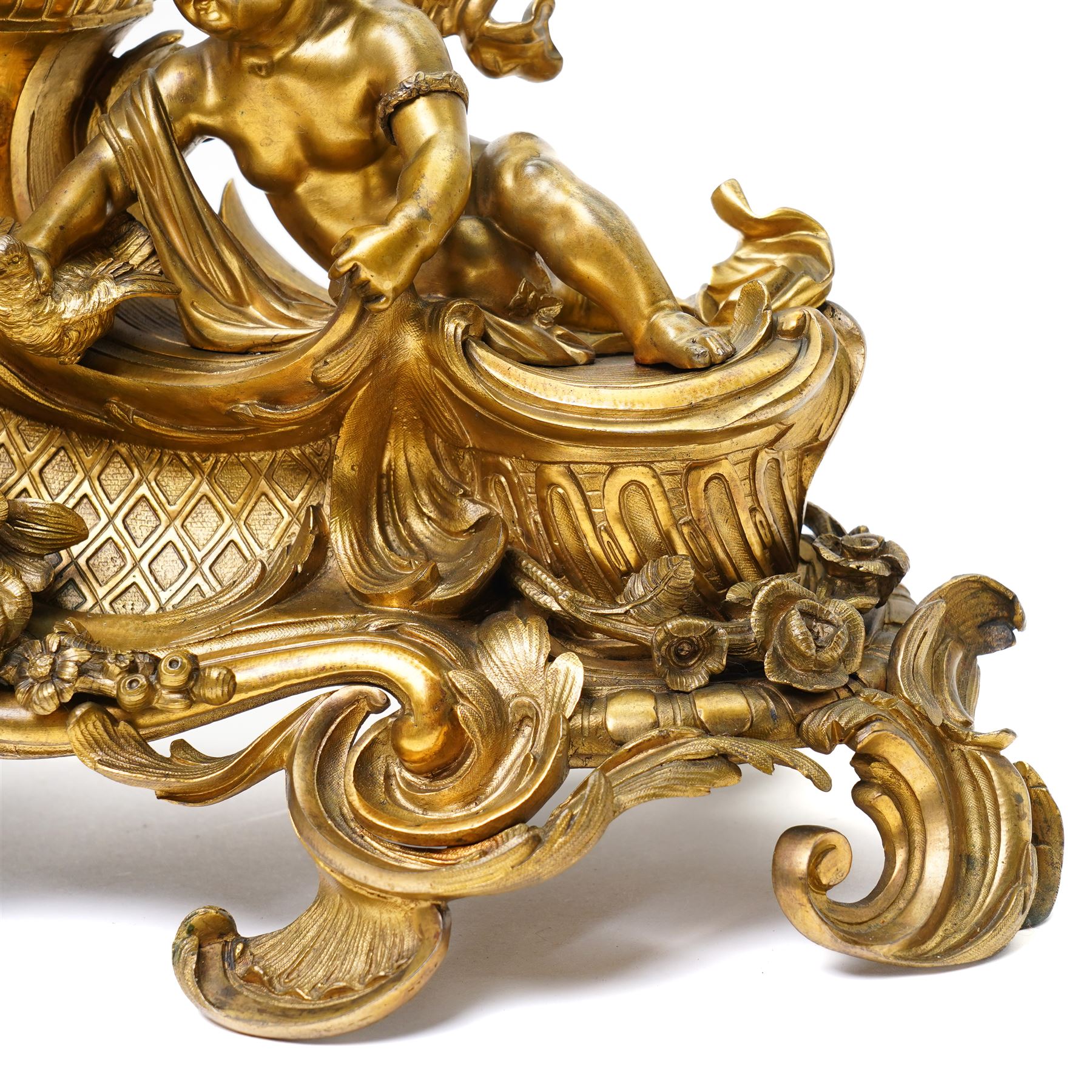 French-large late 19th-century 8-day Louis XV style gilt bronze mantel clock, with a cast rococo style case, elaborate C-scrolls, shells, and floral sprays, surmounted by a seated putto and goat symbolising pastoral love, flanked by two further seated putti on a scrolled foliate base, 5