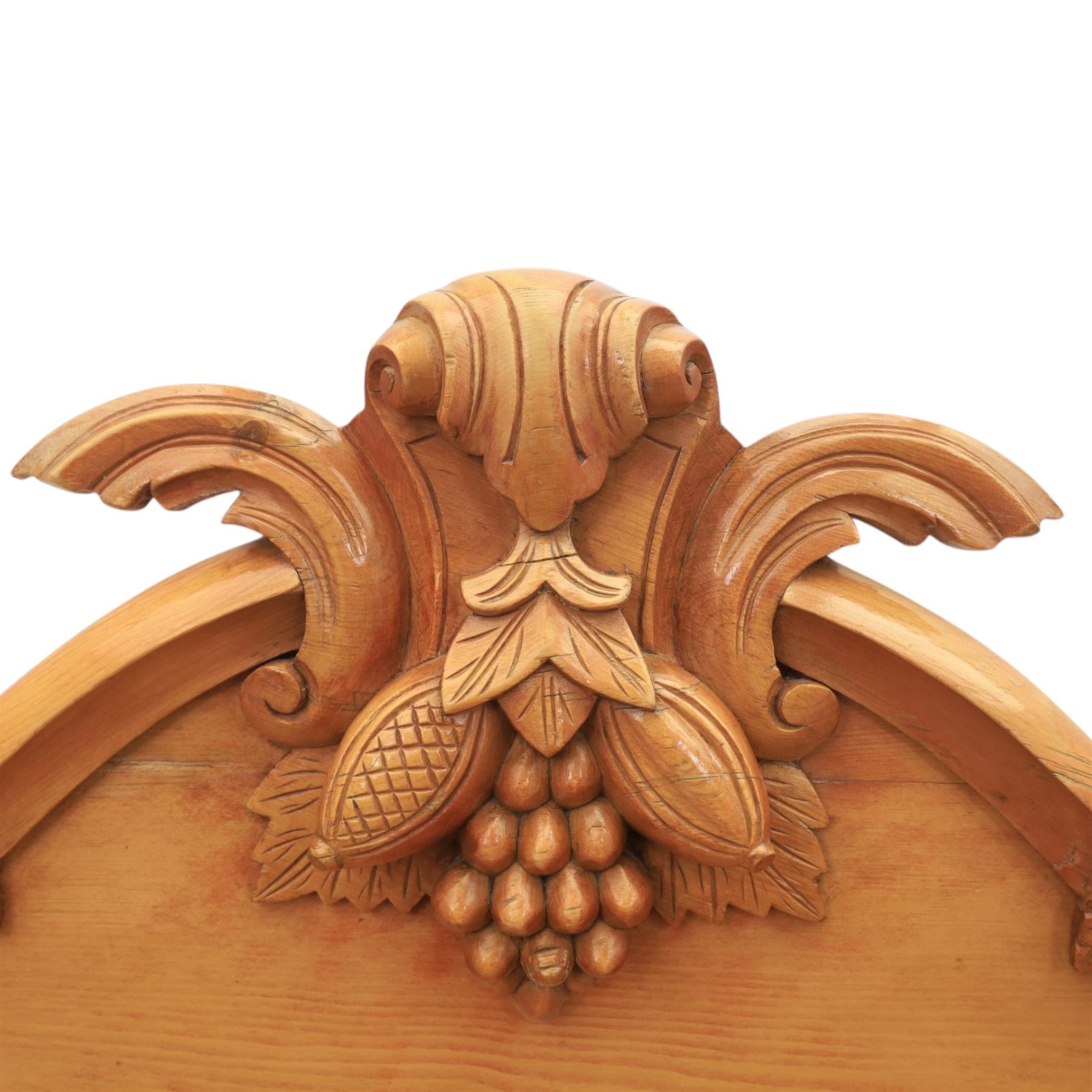 Victorian pine chiffonier, shaped moulded top with raised scroll carved back surmounted by carved fruit and foliate crest, fitted with two frieze drawers over two panelled cupboard doors, the outer cupboards of bowed form, carved foliate corbels, on plinth base