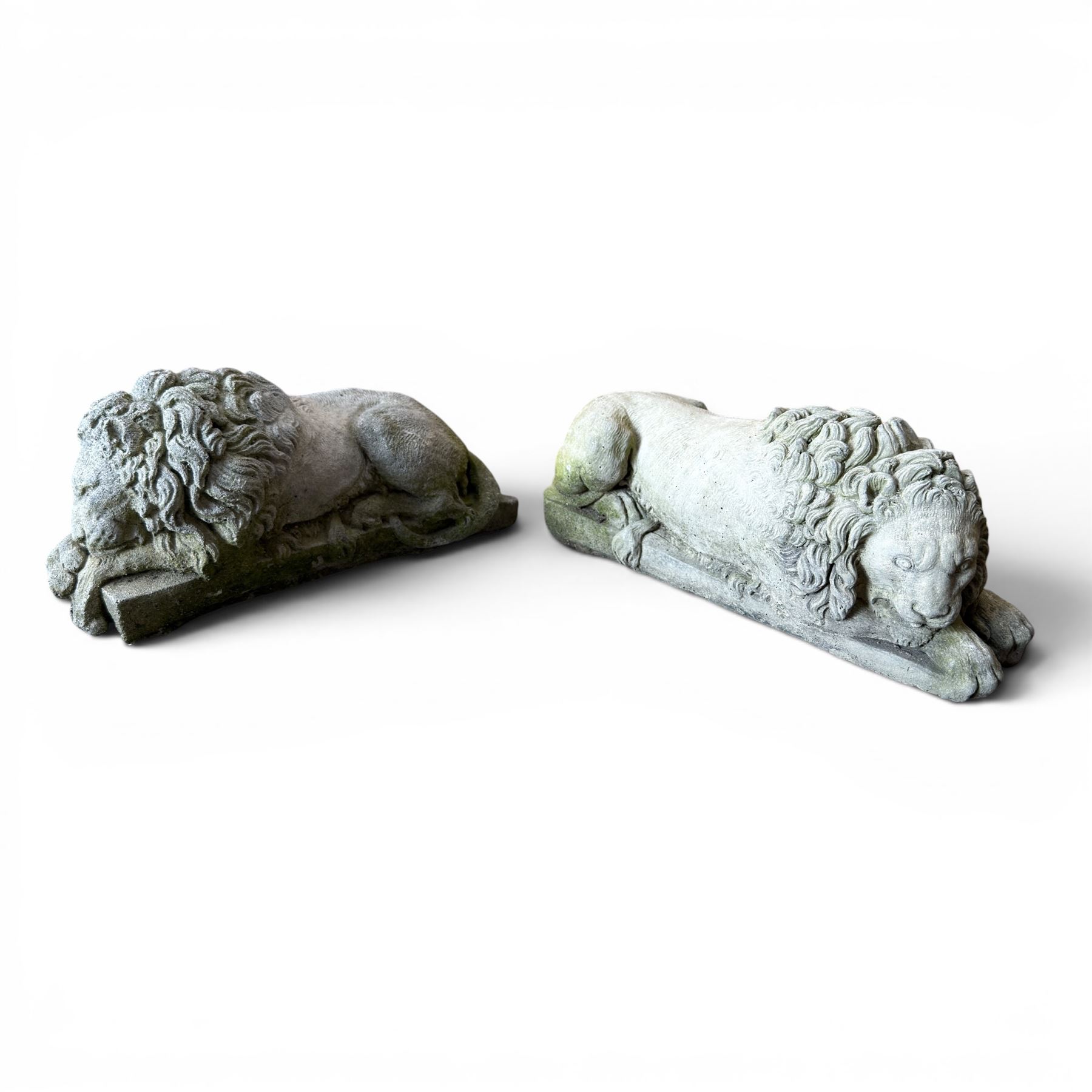 Pair of cast stone seat lions, male and female figure, and a miniature pair of cast stone lions