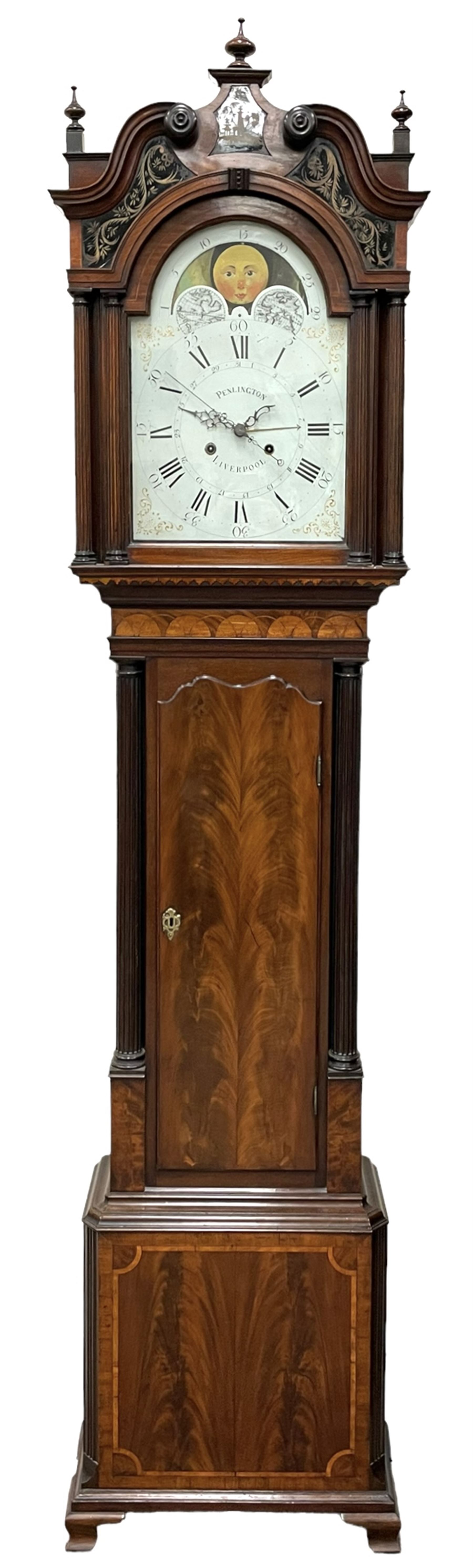 Penlington of Liverpool – early 19th century 8-day mahogany longcase clock, swans neck pediment with three turned wooden finials and verre eglomise panels, trunk with reeded columns and wavy topped door, plinth with canted corners on bracket feet, painted break-arch dial with Roman numerals and five-minute Arabic’s, centre sweep calendar and seconds hands, blue steel serpentine hands, signed beneath a painted rolling moon in the arch PENLINGTON, LIVERPOOL, eight day four pillar movement, anchor escapement and rack striking on a bell. With pendulum and weights.  The Penlington family were prolific clockmakers in 19th century Liverpool working from several addresses in the city, also recorded as chronometer and chronograph makers.