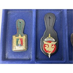 Twelve French military metal badges mounted on leather fobs including Legion, Artillery, Parachutist, Air Force, Infantry etc