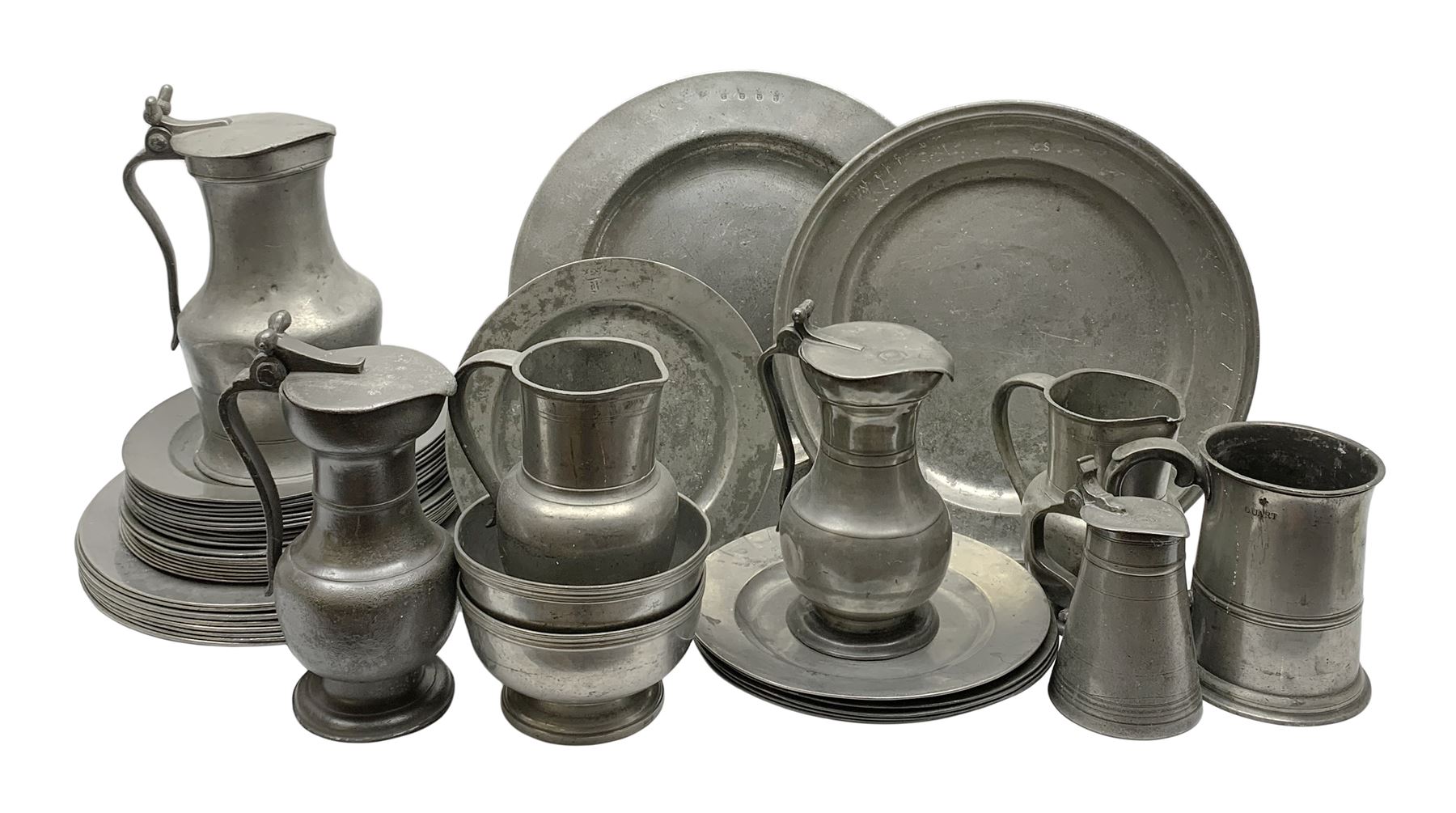 Collection of 18th and 19th century pewter, comprising two chargers, eight large plates, twenty six smaller plates, two bowls, three lidded measures, two jugs, tappit hen, and tankard, the plates with various marks and touch marks, including pseudo 'hallmarks', largest charger 37cm, large plates D30cm, smaller plates D24.5cm, tappit hen H26.5cm