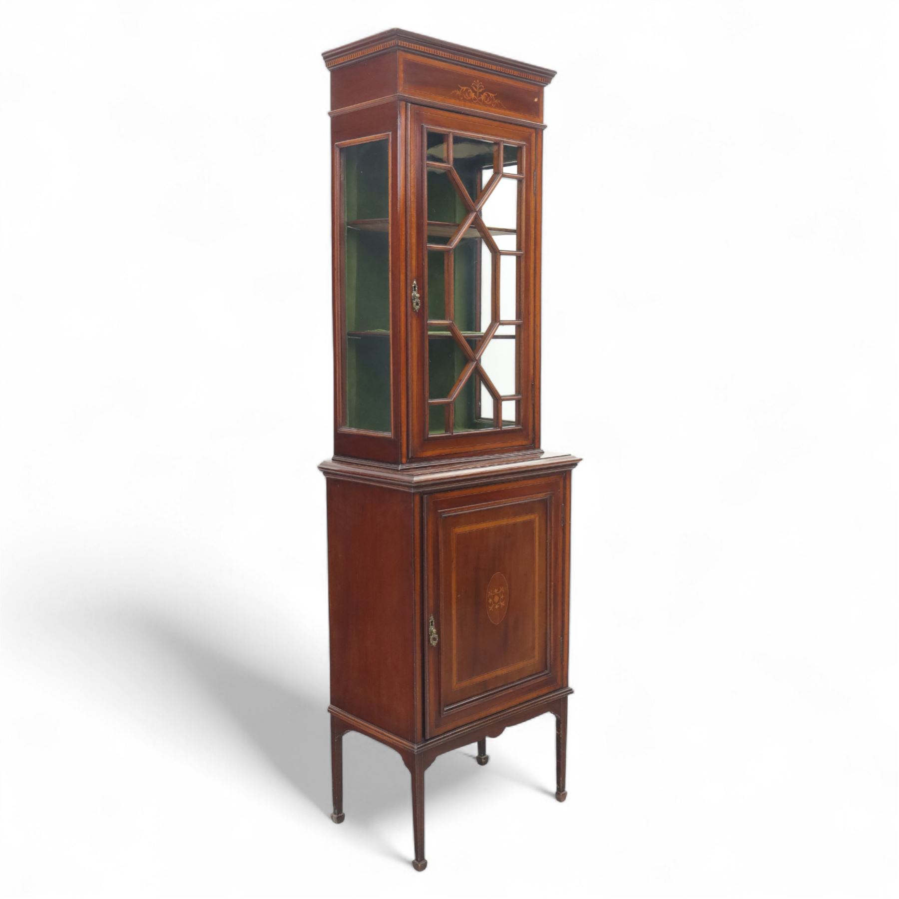 Edwardian inlaid mahogany display cabinet, the moulded cornice above an astragal glazed door enclosing two baize lined shelves, the lower section with a panelled cupboard door, raised on square tapering supports