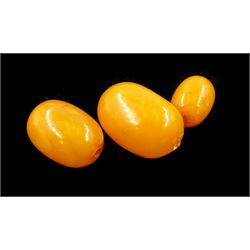 Single strand graduating oval butterscotch amber bead necklace, with three additional loose amber beads