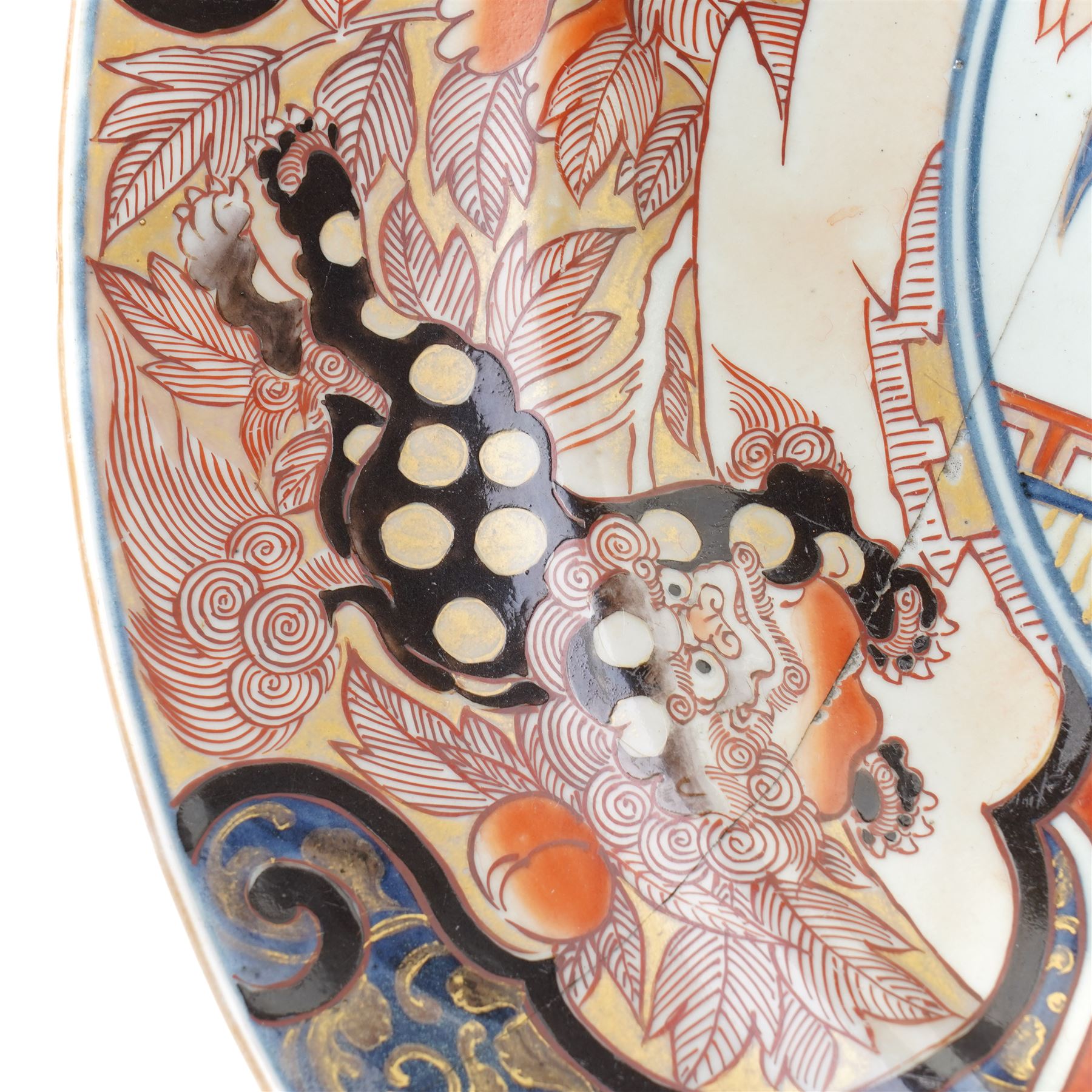 Japanese 18th century Edo period Imari porcelain charger, painted with a central peony in vase within a border of kiku and spotted shi-shi, D54cm 