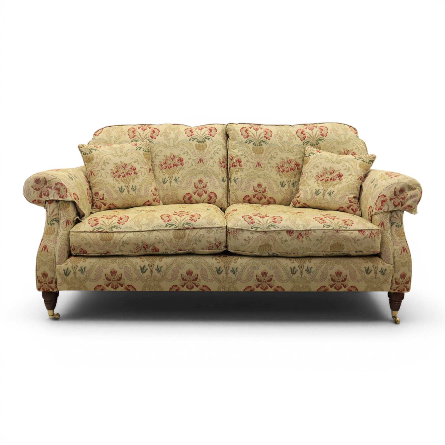Parker Knoll - 'Henley' floral fabric living room suite, comprising a two seat sofa and pair of armchairs, raised on dark stained turned feet raised on brass castors

Armchairs (H 99cm, W 95cm, D 100cm)