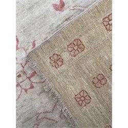 Persian design pale ivory ground carpet, decorated with stylised plant and leaf motifs in pale red